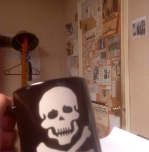 Raising my mug to The Door from my vantage point behind my desk — and hoping no one uses the commode this morning.